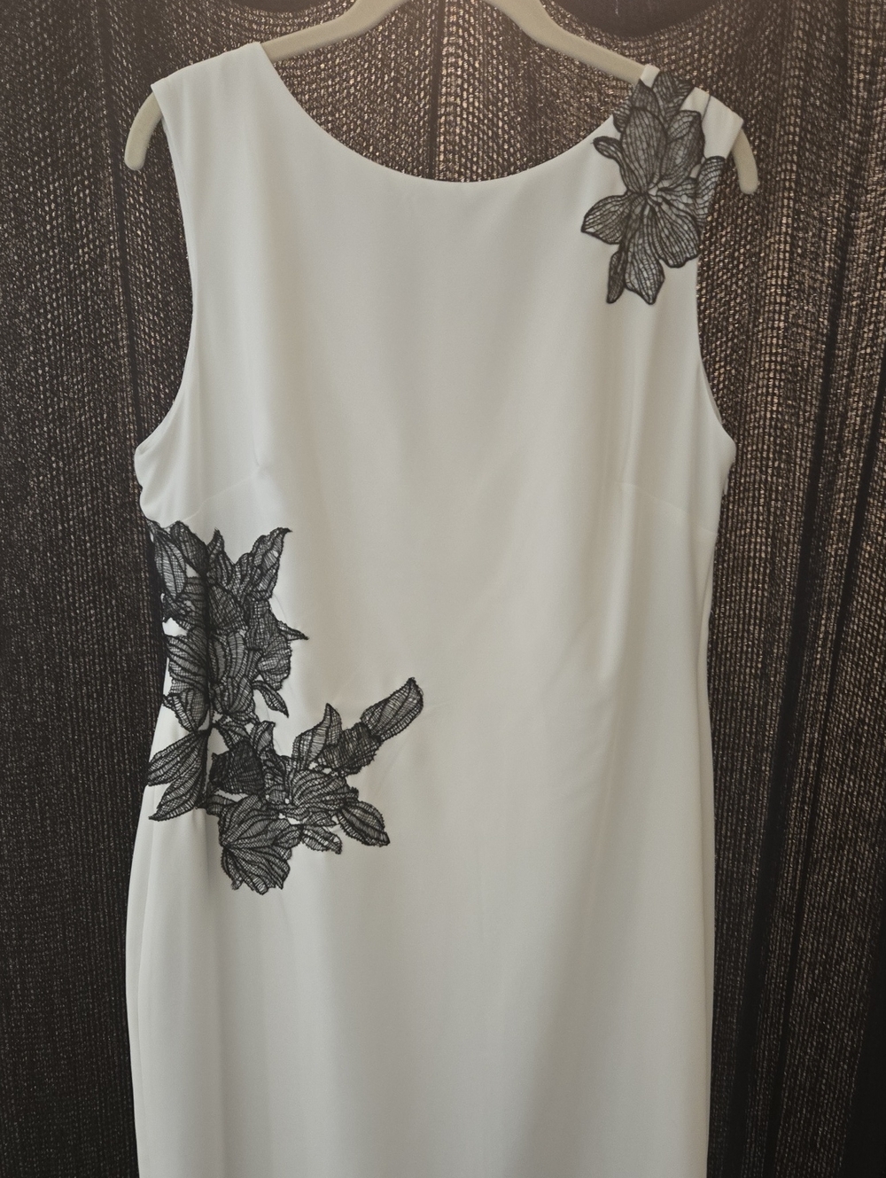 Elegant White Sleeveless Dress with Black Floral Appliqué